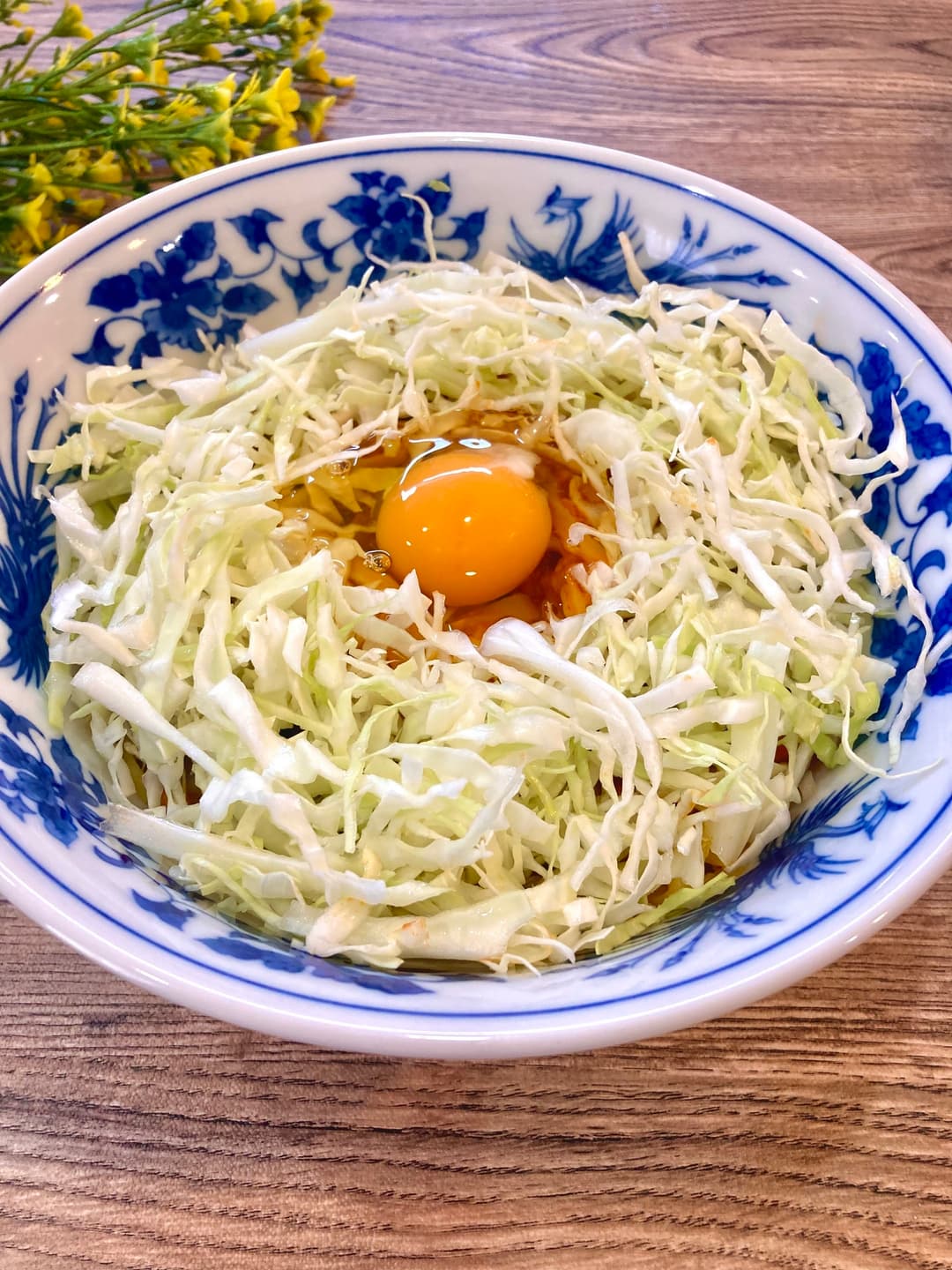 キャベツと生卵トッピングの汁なし坦々麺の完成写真